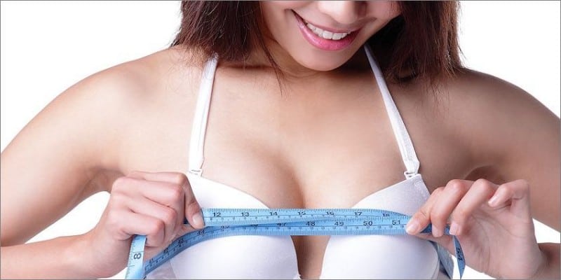 Woman measuring her breast
