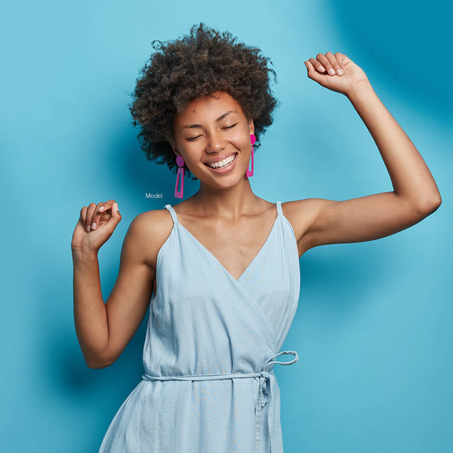 Woman celebrating with arms raised